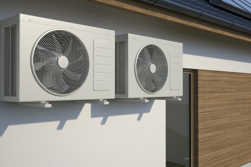 Air conditioners attached to building.