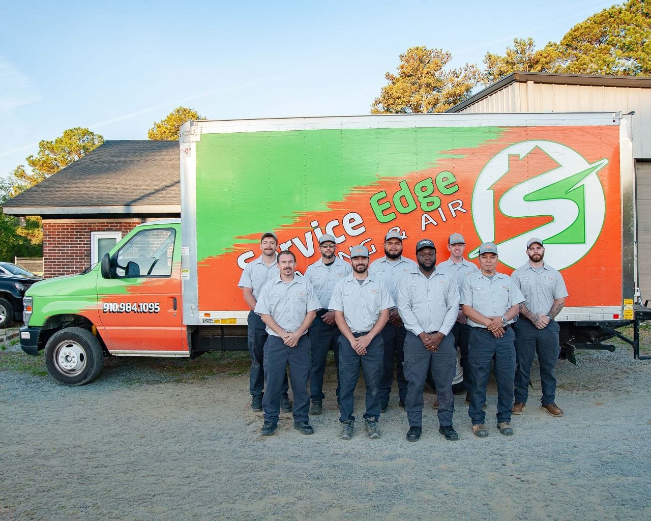 Image of the Service Edge team posed in front of a branded box truck.